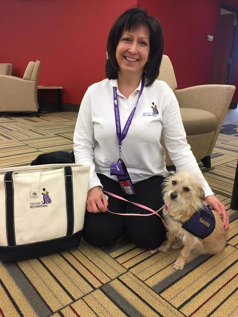 Woman with dog wearing service vest.