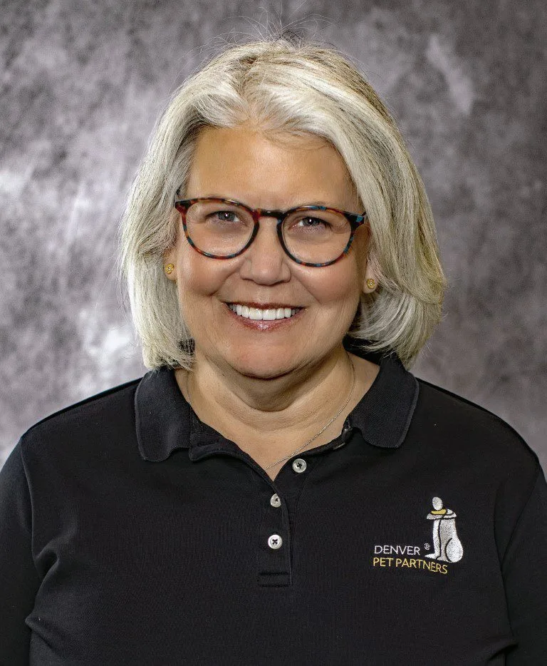 Woman smiling wearing glasses and Denver Pet Partners shirt.