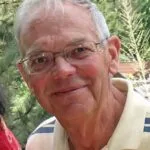 A man with glasses and white hair.