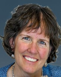 A woman with short hair and blue eyes.